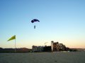 Parachute jumper landing on the beach
